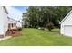 Expansive backyard with lush green lawn and mature trees provides plenty of room to play at 541 Mallie Pearce Rd, Zebulon, NC 27597