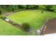 Large fenced backyard with lush green grass, landscaping beds, and plenty of space for outdoor activities at 541 Mallie Pearce Rd, Zebulon, NC 27597