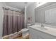 Bathroom featuring a single sink vanity, toilet, shower with curtains and wood-look floors at 541 Mallie Pearce Rd, Zebulon, NC 27597