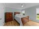 Cozy bedroom featuring a wooden sleigh bed, dresser, ceiling fan, and natural light at 541 Mallie Pearce Rd, Zebulon, NC 27597
