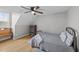 Bedroom with wood floors, a bed, a ceiling fan and a small dresser for storage at 541 Mallie Pearce Rd, Zebulon, NC 27597