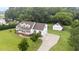 Charming two-story home with a rocking chair front porch, mature landscaping, and a detached garage at 541 Mallie Pearce Rd, Zebulon, NC 27597