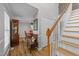Inviting foyer with wood flooring, staircase, and a glimpse into the dining area, creating a warm welcome at 541 Mallie Pearce Rd, Zebulon, NC 27597