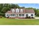 Charming two-story home featuring a large front yard and inviting front porch with rocking chairs at 541 Mallie Pearce Rd, Zebulon, NC 27597