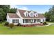 Charming two-story home with a welcoming front porch, well-manicured lawn, and mature landscaping at 541 Mallie Pearce Rd, Zebulon, NC 27597