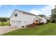 A large two-car garage with an apartment above, along with a wooden deck and patio area at 541 Mallie Pearce Rd, Zebulon, NC 27597