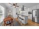 Well-lit kitchen boasts granite counters, an island with barstool seating, and stainless steel appliances at 541 Mallie Pearce Rd, Zebulon, NC 27597