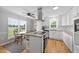 Eat-in kitchen featuring stainless appliances, an island with seating, and a window overlooking the backyard at 541 Mallie Pearce Rd, Zebulon, NC 27597