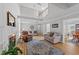 Open living room with a fireplace, hardwood floors, and a view of the staircase to the second floor at 541 Mallie Pearce Rd, Zebulon, NC 27597