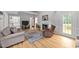 Open concept living room with hardwood floors, a fireplace, and access to the kitchen at 541 Mallie Pearce Rd, Zebulon, NC 27597