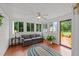 Bright sunroom filled with lots of natural light, features a ceiling fan and an access door to a deck at 541 Mallie Pearce Rd, Zebulon, NC 27597