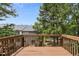 View from the wooden back deck shows trees and the home's roof next door at 5545 Crabtree Park Ct, Raleigh, NC 27612