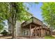 A view of the back of the home shows the siding, deck, and wooded area at 5545 Crabtree Park Ct, Raleigh, NC 27612