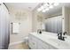 Bathroom with double sink vanity, neutral walls, and large mirror at 5545 Crabtree Park Ct, Raleigh, NC 27612