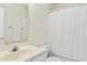 Bright bathroom featuring a white vanity and a shower with a white curtain at 5545 Crabtree Park Ct, Raleigh, NC 27612