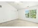 Bright bedroom with a ceiling fan, window with blinds, and spacious closet at 5545 Crabtree Park Ct, Raleigh, NC 27612