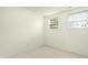 Simple bedroom with two windows and light carpet at 5545 Crabtree Park Ct, Raleigh, NC 27612