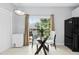 Bright breakfast nook featuring a glass table set and large window with backyard views at 5545 Crabtree Park Ct, Raleigh, NC 27612