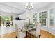 Dining area with a glass table, hardwood floors, and lots of natural light at 5545 Crabtree Park Ct, Raleigh, NC 27612