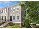 Exterior shot of a townhome with a charming architectural style and mature trees at 5545 Crabtree Park Ct, Raleigh, NC 27612