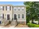 Charming townhome with a black door, arched windows, and well-maintained landscaping at 5545 Crabtree Park Ct, Raleigh, NC 27612