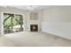 Cozy living room with a fireplace, carpet, ceiling fan, and sliding doors to the outside at 5545 Crabtree Park Ct, Raleigh, NC 27612