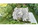 Stunning aerial view of a home with mature trees, beautiful landscaping, and in-ground pond at 5920 Two Pines Trl, Wake Forest, NC 27587
