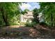 Spacious backyard with lush greenery, featuring a bench, providing a serene outdoor retreat at 5920 Two Pines Trl, Wake Forest, NC 27587