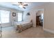 Light-filled bedroom offers plush carpet, dual windows, and a doorway to an additional room at 5920 Two Pines Trl, Wake Forest, NC 27587