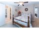 Bedroom includes floral bedding, ceiling fan, and an ensuite bathroom providing comfort and convenience at 5920 Two Pines Trl, Wake Forest, NC 27587