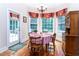Charming breakfast nook featuring a round table, corner windows, and a chandelier above the table at 5920 Two Pines Trl, Wake Forest, NC 27587