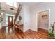 View of the entryway with hardwood floors, staircase with iron spindles, and decorative front door at 5920 Two Pines Trl, Wake Forest, NC 27587