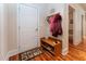 Entryway with white door, coat rack and bench with shoe storage at 5920 Two Pines Trl, Wake Forest, NC 27587