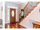 Elegant entryway with hardwood floors, staircase, and front door featuring decorative glass panels at 5920 Two Pines Trl, Wake Forest, NC 27587