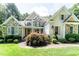 Attractive stone and siding home with landscaped front yard and American flag at 5920 Two Pines Trl, Wake Forest, NC 27587