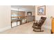 Bright hallway features neutral carpet, wooden railing with wrought iron details, and view to living area at 5920 Two Pines Trl, Wake Forest, NC 27587