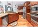 Kitchen featuring custom wood cabinets, stainless appliances, granite countertops and hardwood floors at 5920 Two Pines Trl, Wake Forest, NC 27587