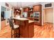 A kitchen with custom wood cabinets, stainless appliances, hardwood floors, and granite countertops at 5920 Two Pines Trl, Wake Forest, NC 27587