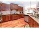 A kitchen with custom cabinets, hardwood floors, stainless appliances, and granite countertops at 5920 Two Pines Trl, Wake Forest, NC 27587