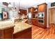 Kitchen with granite counters, wood cabinets, stainless steel appliances and room for food prep and cooking at 5920 Two Pines Trl, Wake Forest, NC 27587
