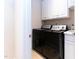 A laundry room featuring a front-load washer and dryer, along with white cabinets for storage at 5920 Two Pines Trl, Wake Forest, NC 27587