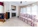 A comfortable living room features a fireplace, carpet, and large windows at 5920 Two Pines Trl, Wake Forest, NC 27587