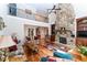 Open living room featuring a stone fireplace, tall ceilings, and a view of the second-floor balcony at 5920 Two Pines Trl, Wake Forest, NC 27587