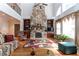 Spacious living room with a stone fireplace, built-in bookcases, high ceilings, and oversized windows at 5920 Two Pines Trl, Wake Forest, NC 27587