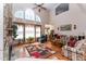 Bright living room with a stone fireplace, tall ceilings, arched windows with nice curtains and room for sitting at 5920 Two Pines Trl, Wake Forest, NC 27587