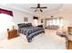 A main bedroom offers a seating area, ceiling fan, tray ceiling, and neutral carpet at 5920 Two Pines Trl, Wake Forest, NC 27587