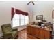 This office features wood floors, a ceiling fan, natural light, and a desk with built in shelving at 5920 Two Pines Trl, Wake Forest, NC 27587