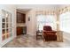 A sitting area with wet bar, custom cabinets and tile floors at 5920 Two Pines Trl, Wake Forest, NC 27587