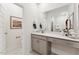 Bright bathroom featuring a vanity with a quartz countertop and decorative fixtures, and view into the toilet room at 600 Hedrick Ridge Road # 310 209, Cary, NC 27519