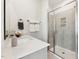 Modern bathroom with a glass-enclosed shower featuring tiled walls, built in niche, and a sleek white countertop at 600 Hedrick Ridge Road # 310 209, Cary, NC 27519